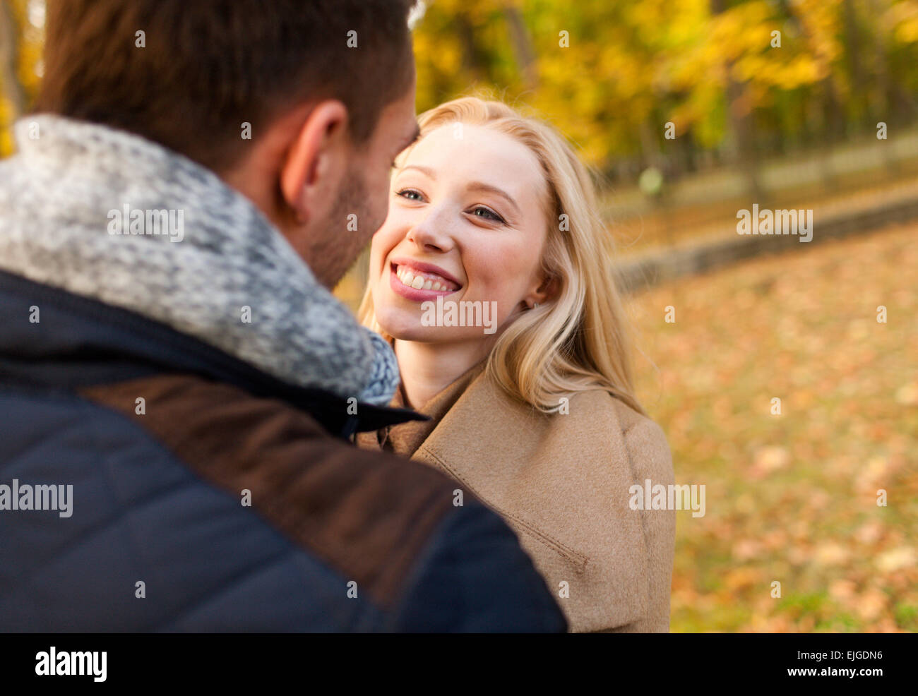 smiling couple hugging in autumn park Stock Photo - Alamy