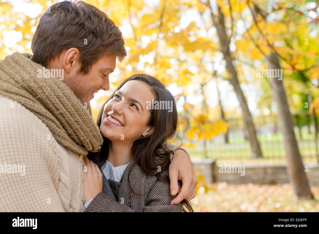 smiling couple hugging in autumn park Stock Photo - Alamy