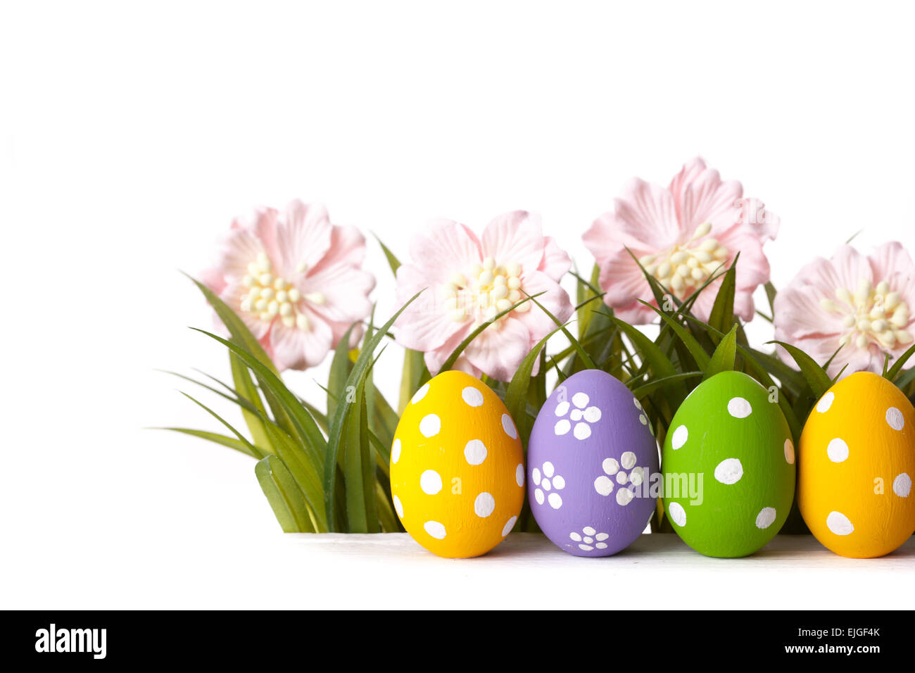 Easter colored eggs on the green grass. Stock Photo