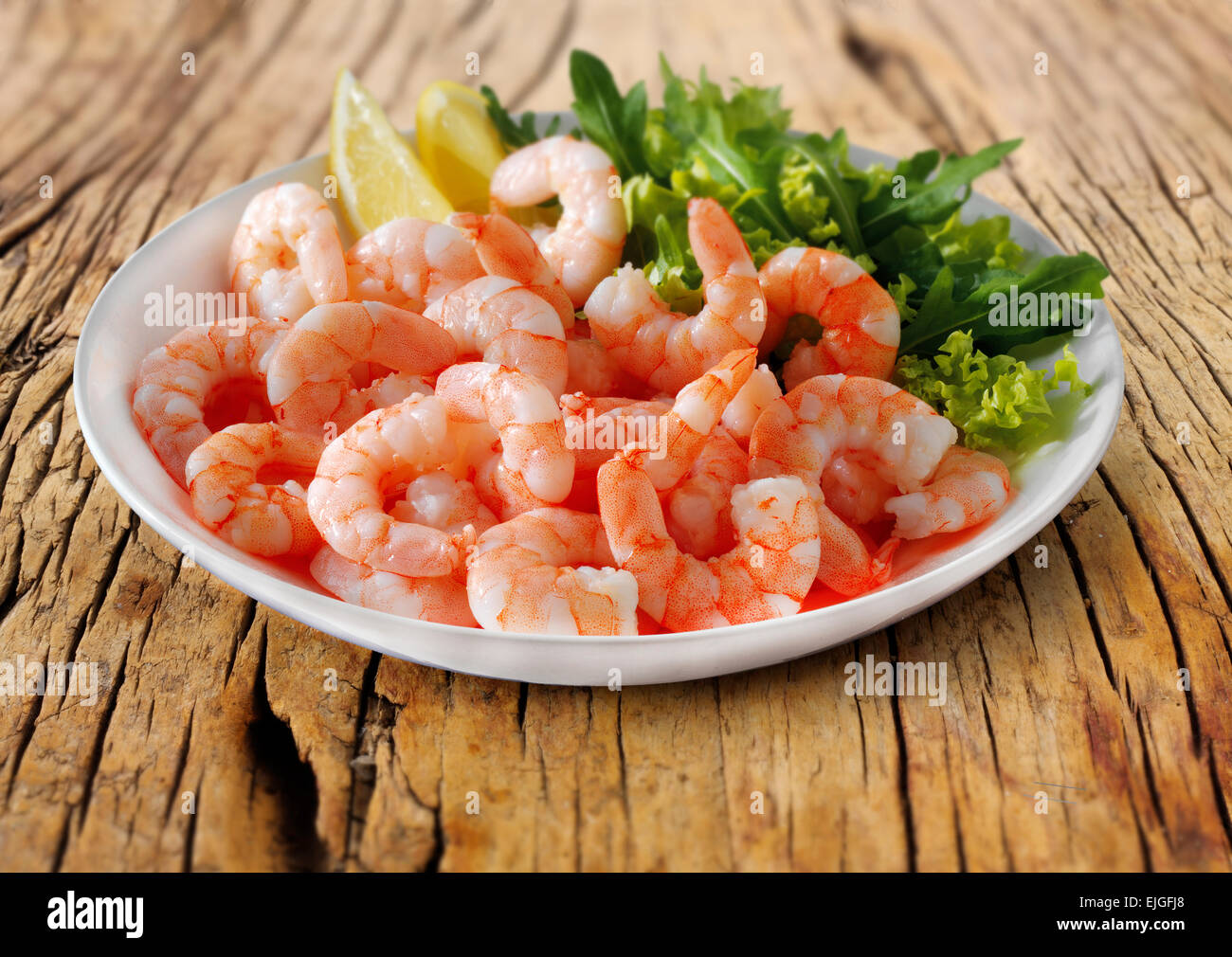 Fresh cooked prawns & salad served on a plate ready to eat Stock Photo