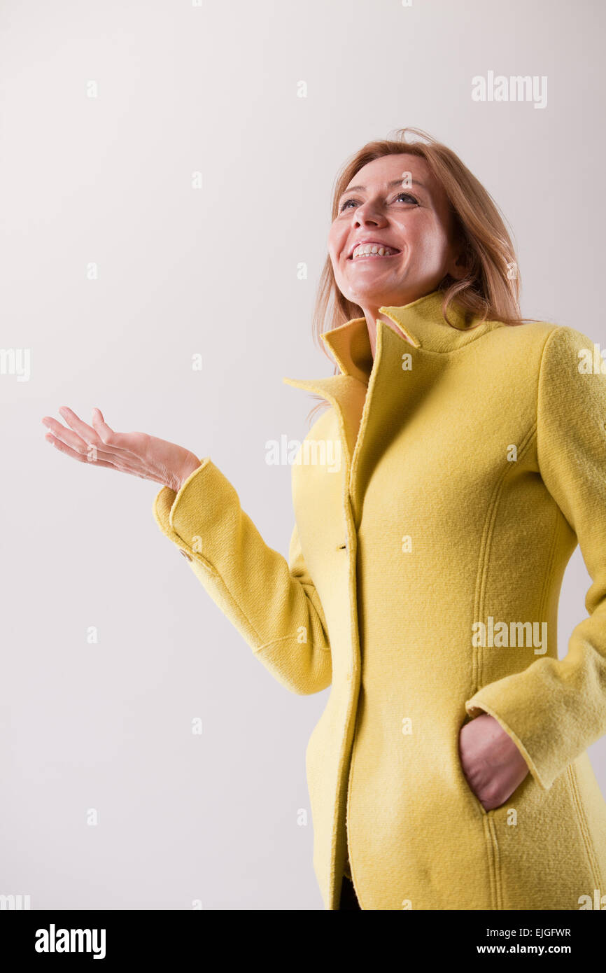 Real woman in yellow coat hi-res stock photography and images - Alamy