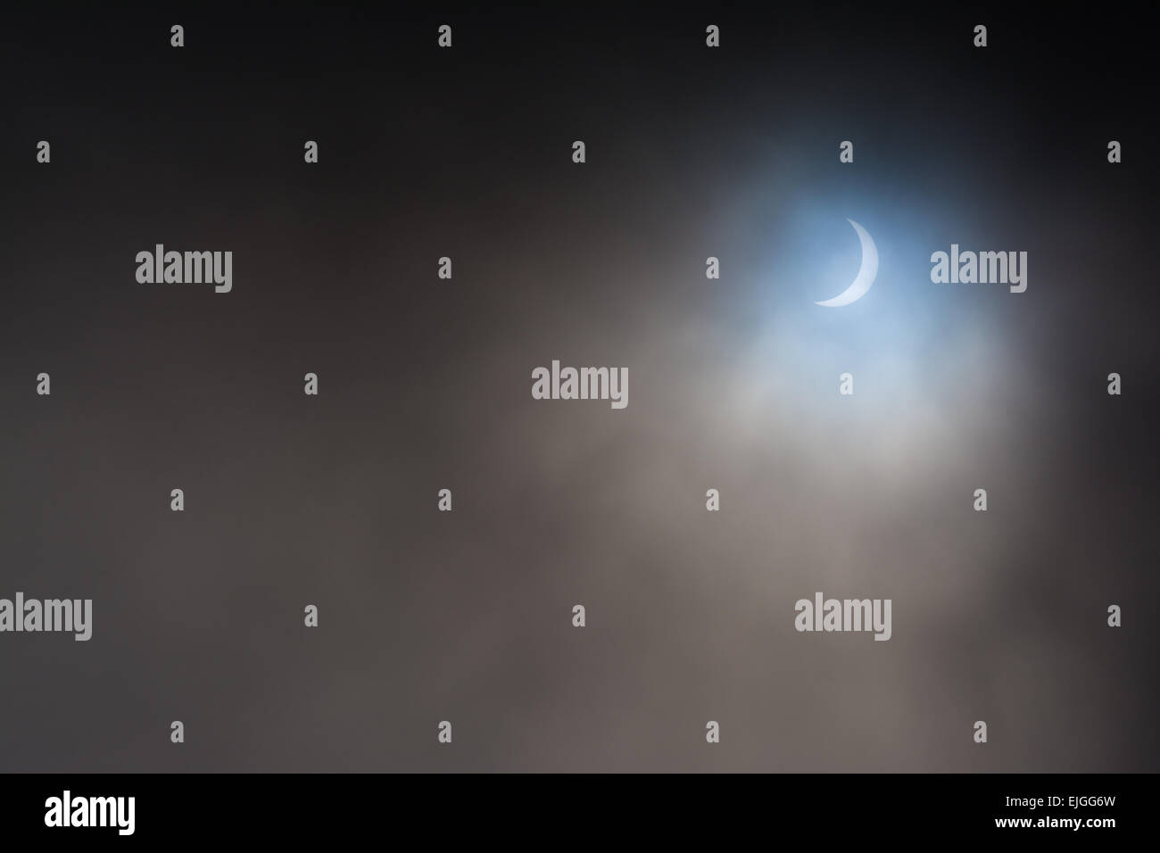 STIRLINGSHIRE, SCOTLAND, UK - 20 MARCH 2015: solar eclipse as moon passes in front of sun on a cloudy day Stock Photo