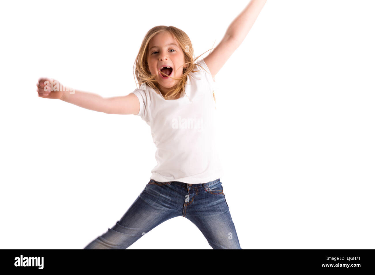 blond kid girl indented jumping high wind on hair denim jeans at white background Stock Photo