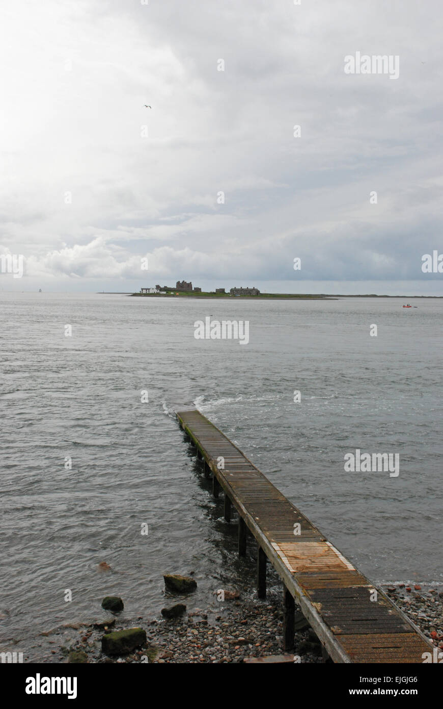 Piel Island off the coast of Cumbria with small boat jetty leading out into the water Stock Photo