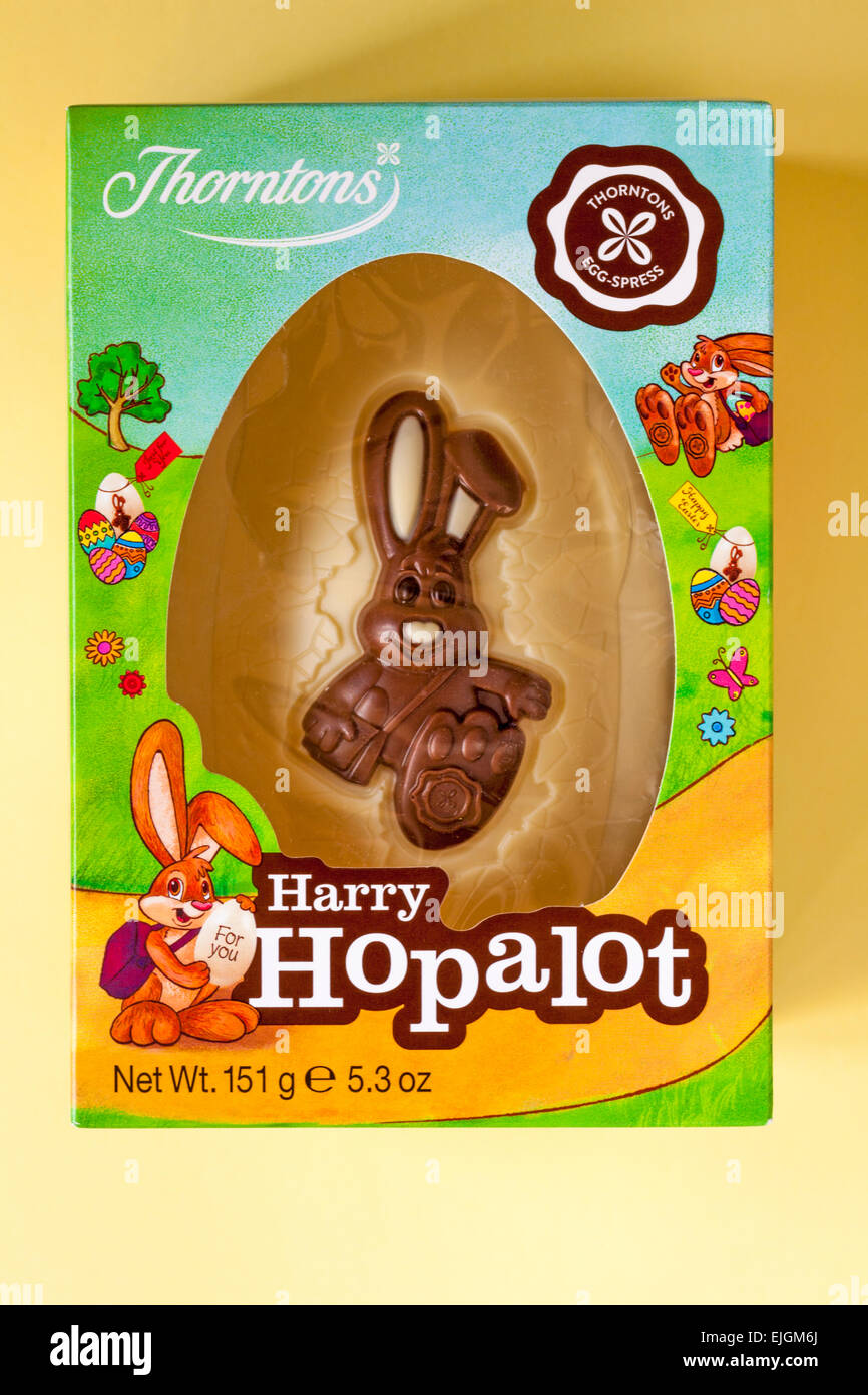 Thorntons Harry Hopalot white chocolate Easter bunny rabbit egg isolated on yellow background ready for Easter Stock Photo