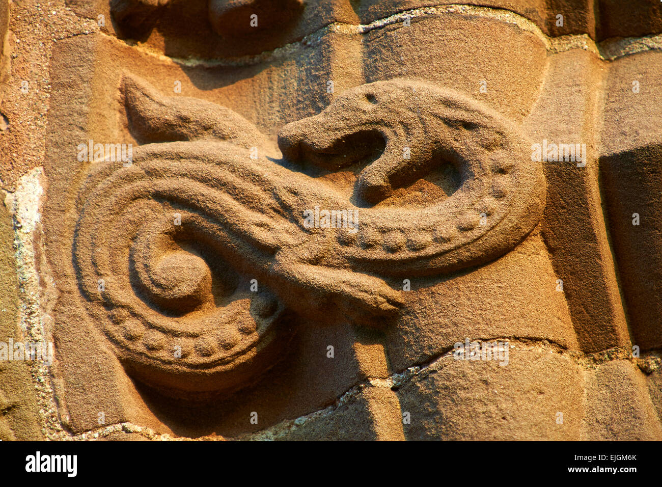 Norman Romanesque relief sculptures of  mythical dragon. St Mary & St David Church, Kilpeck Hereford, England Stock Photo