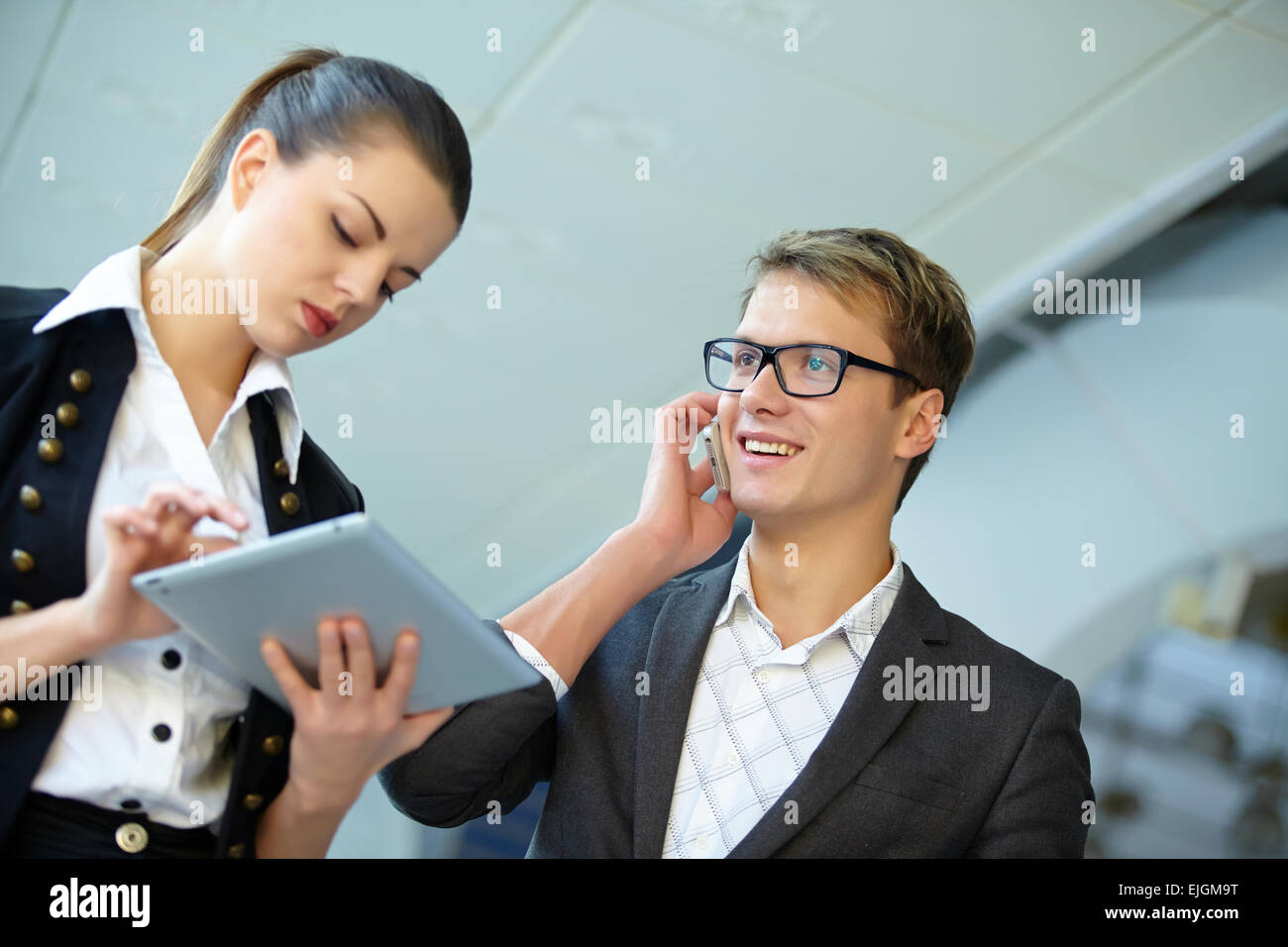 Young business woman and businessman in the hallway Stock Photo - Alamy