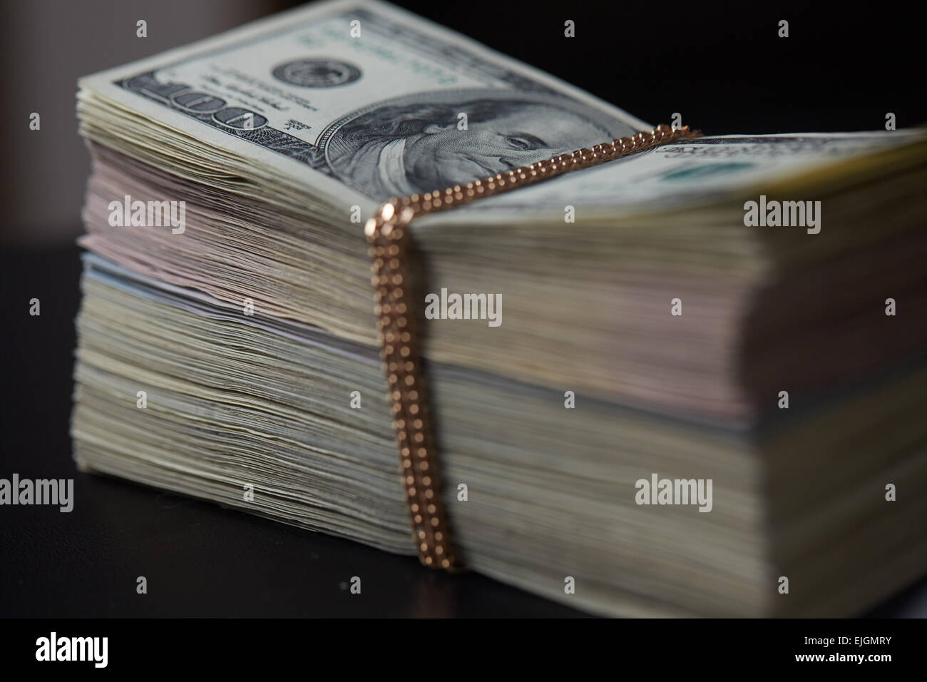 a-bundle-of-money-tied-with-gold-chain-stock-photo-alamy