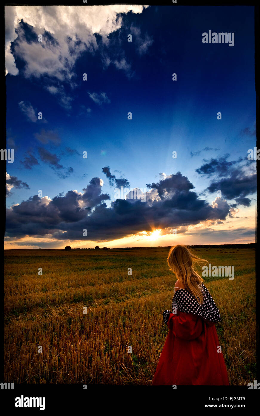 girl in a red dress on nature Stock Photo - Alamy