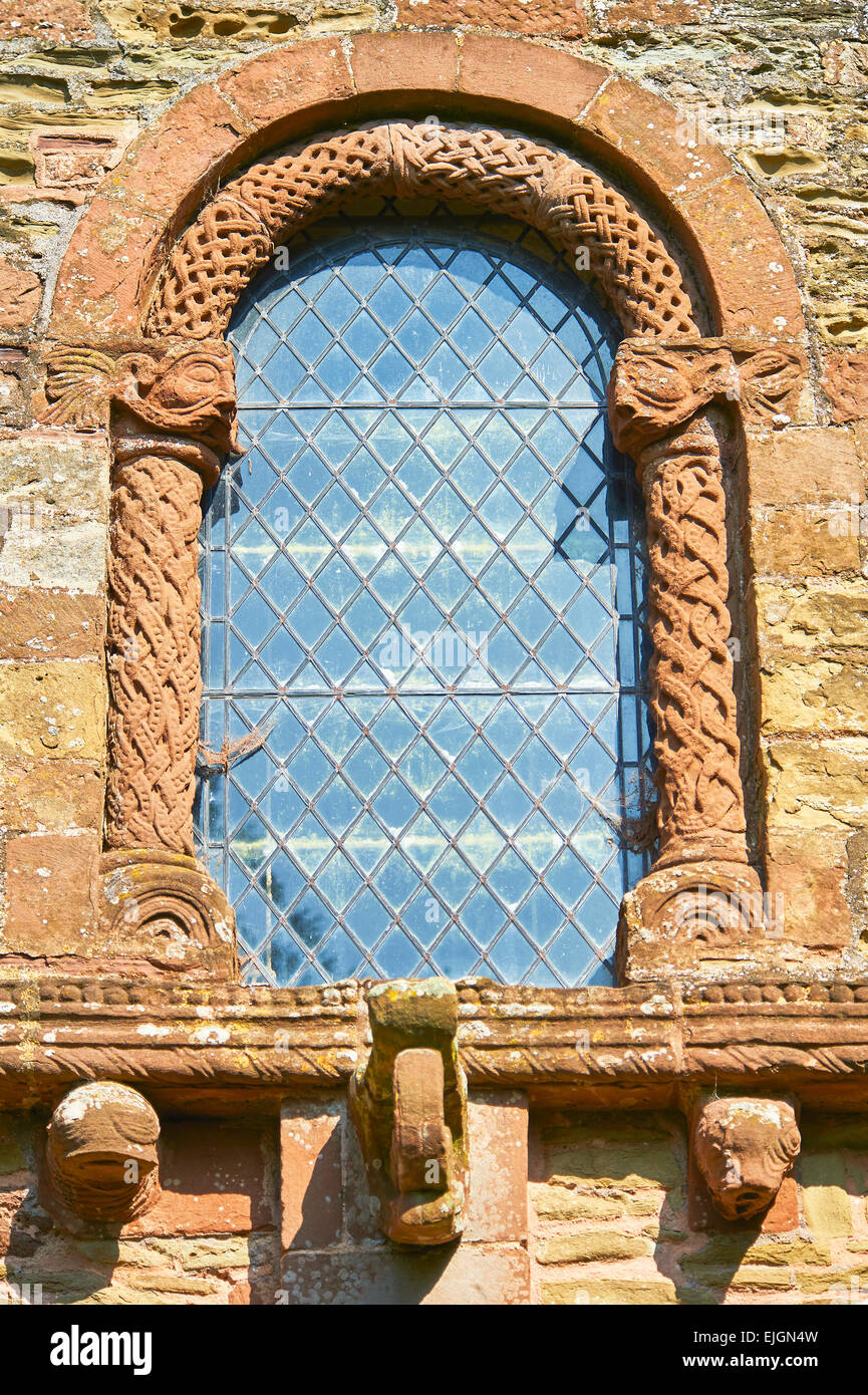 Norman Romanesque relief sculptures of a window with green men