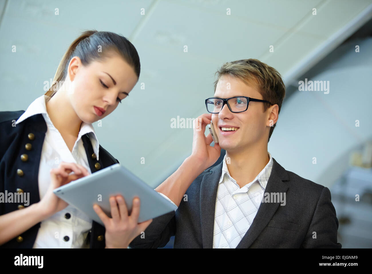 Young business woman and businessman in the hallway Stock Photo - Alamy
