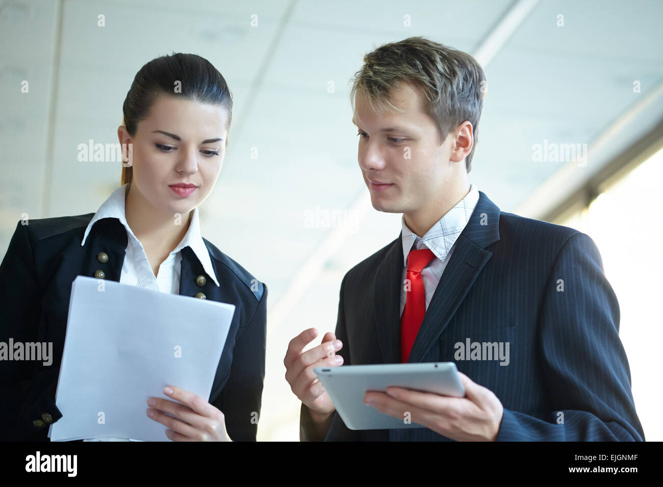 Young business woman and businessman in the hallway Stock Photo - Alamy