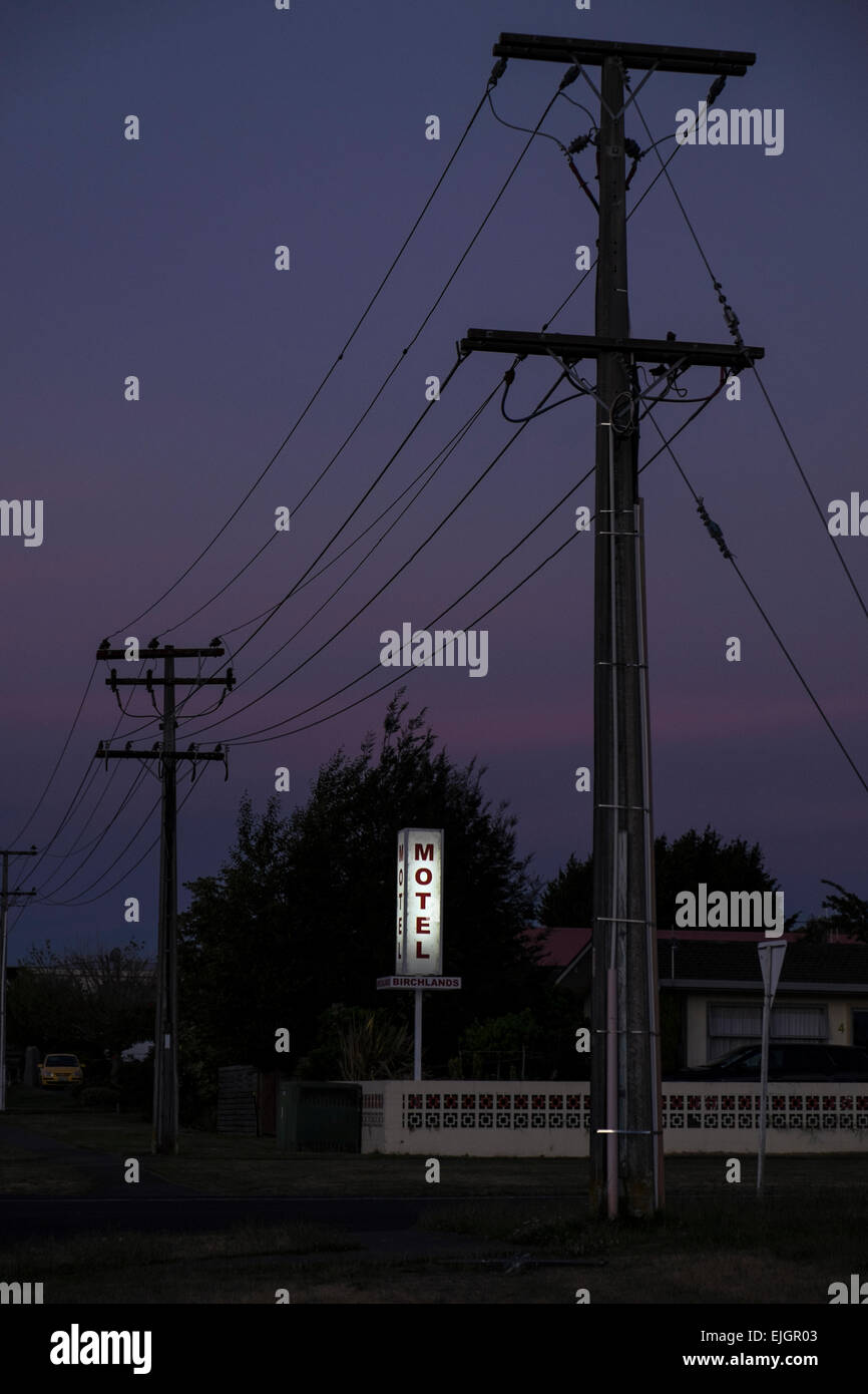 Motel Birchlands neon sign and telegraph poles in Taupo, New Zealand, at dusk. Stock Photo