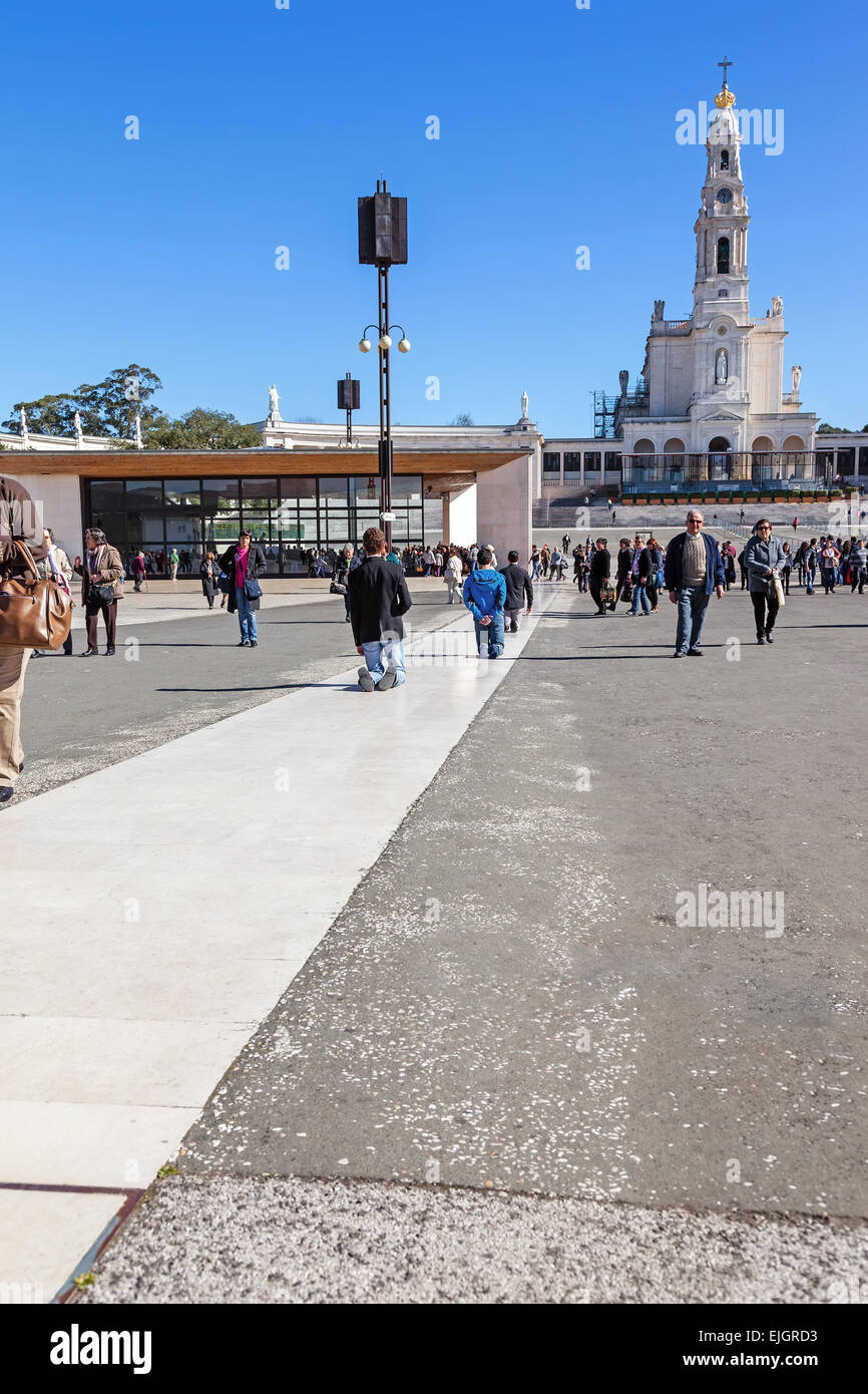 Devotees walk the Penitential Path on knees for vows made to Our Lady after the fulfillment of requests. Stock Photo