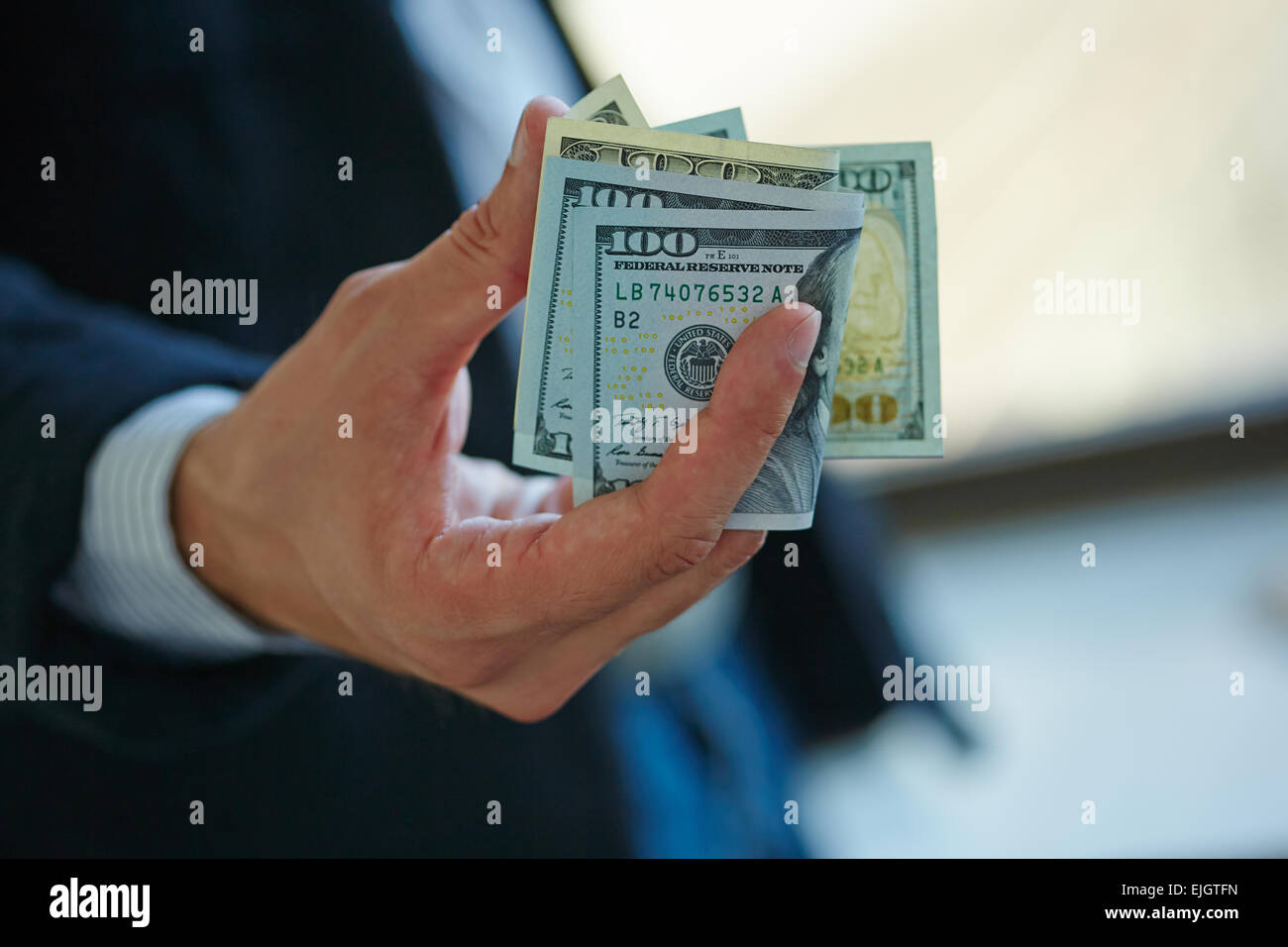 Businessman holding money in his hands Stock Photo