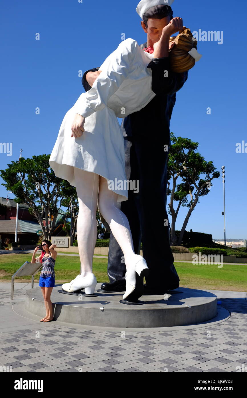 Navy guy kissing nurse