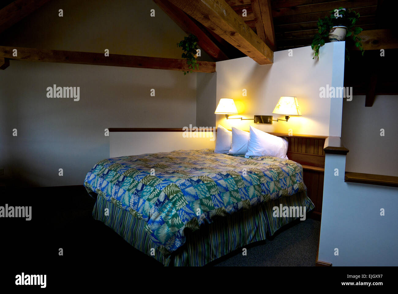 Loft bedroom exposed wooden beams Canadian Princess Fishing Lodge Ucluelet BC Stock Photo