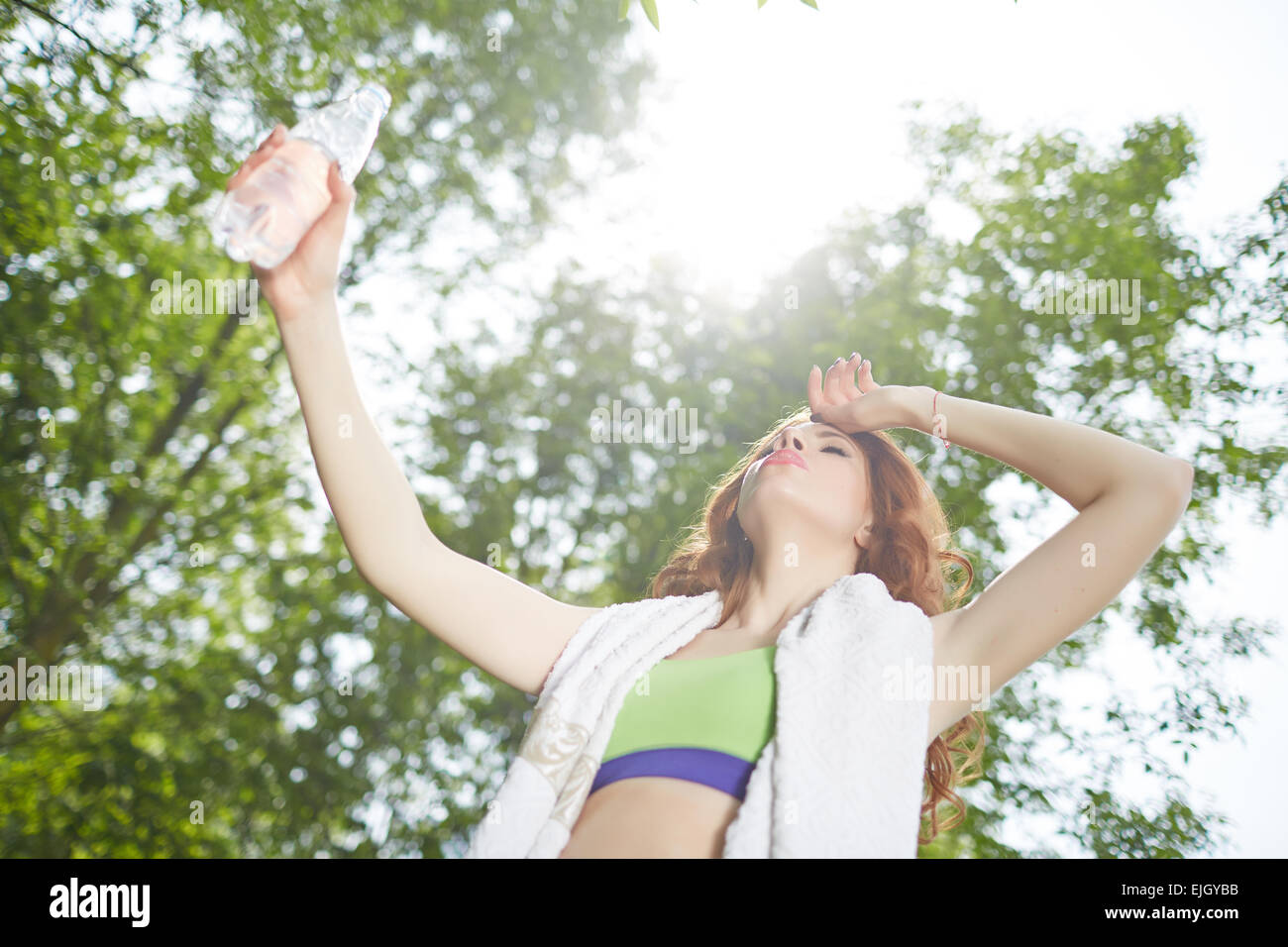 sportswoman with a bottle of water and towel at the park Stock Photo ...