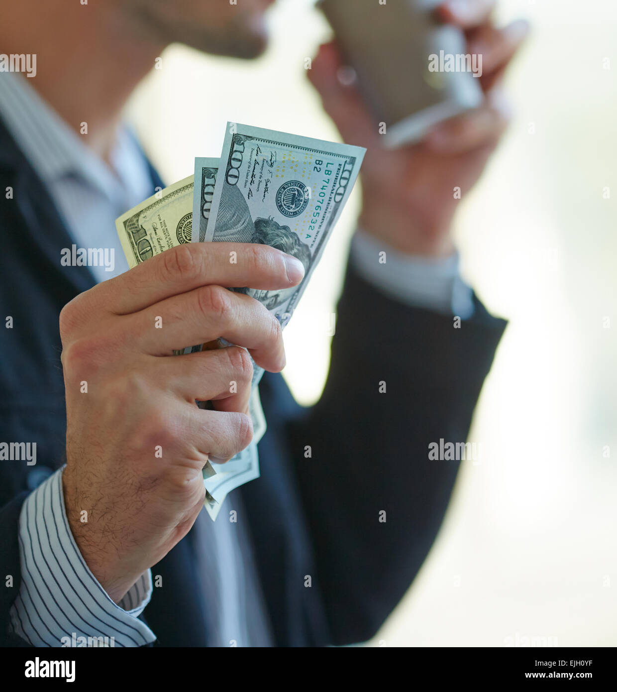 Businessman holding money in his hands Stock Photo