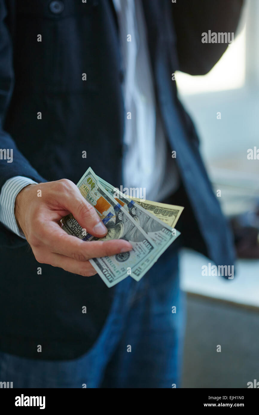 Businessman holding money in his hands Stock Photo