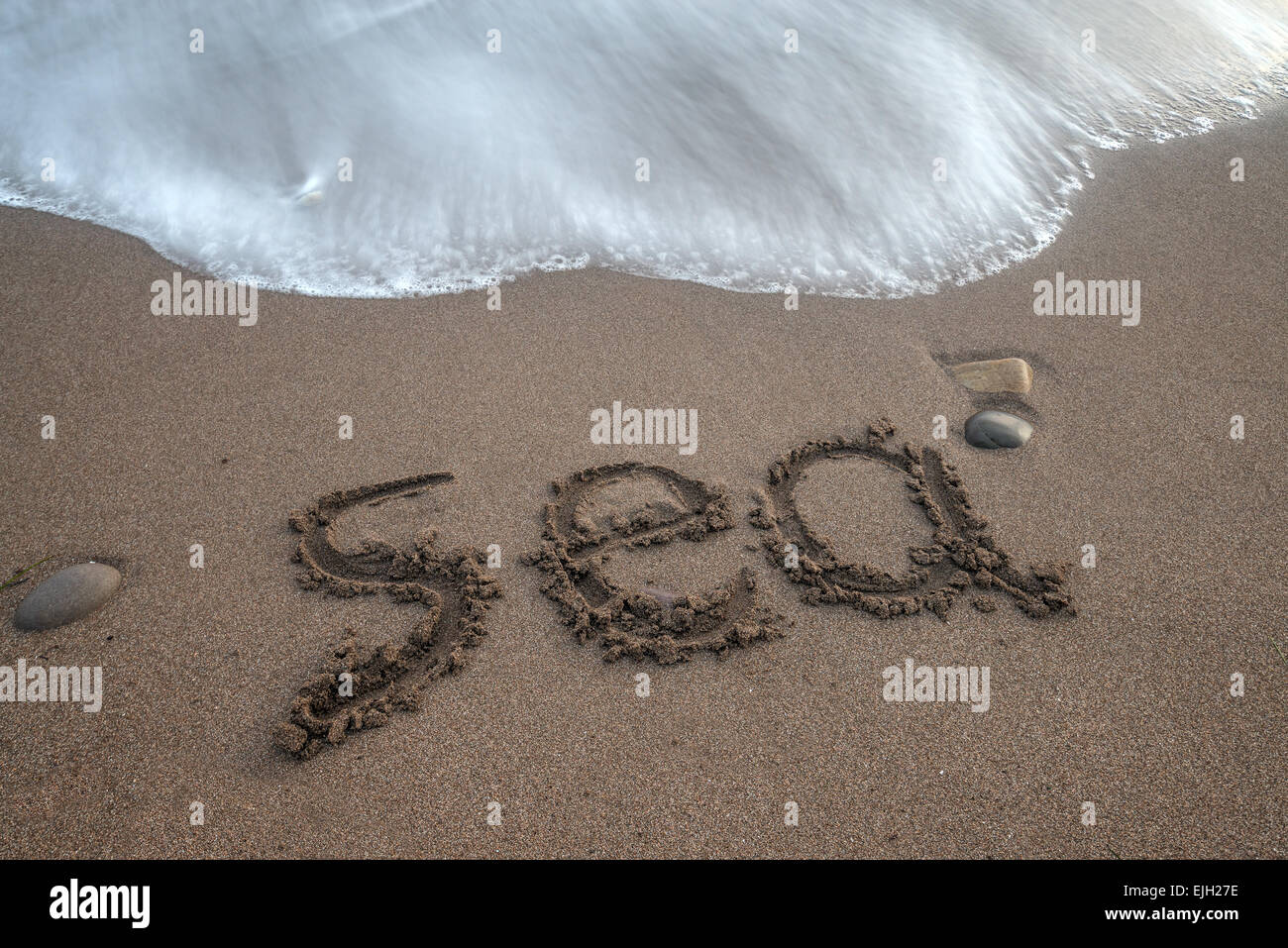 Word 'sea' on sand beach Stock Photo