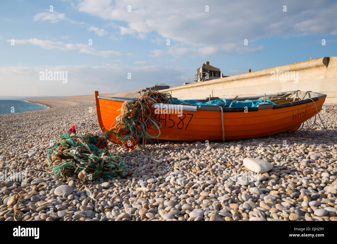 Fishing boat moored on Chesil Beach on Portlandboat on beach Stock