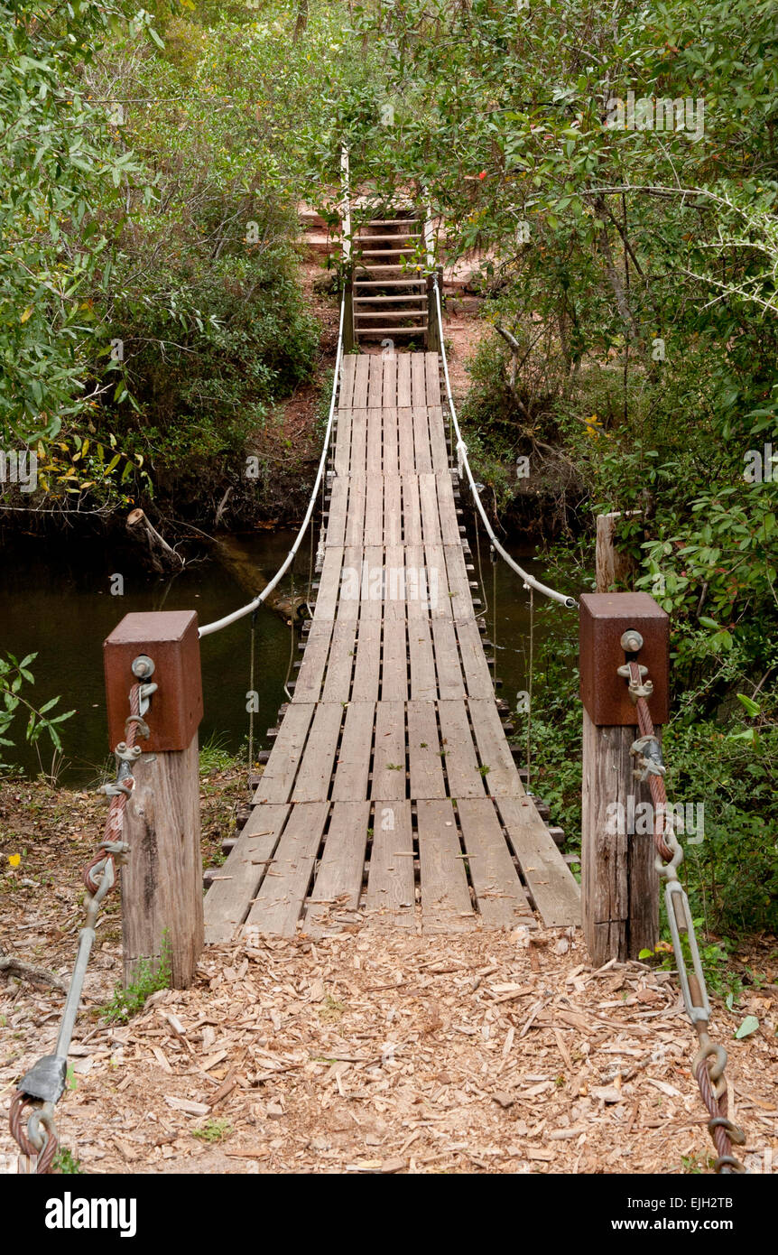 Wooden suspension bridge across a stream Stock Photo Alamy