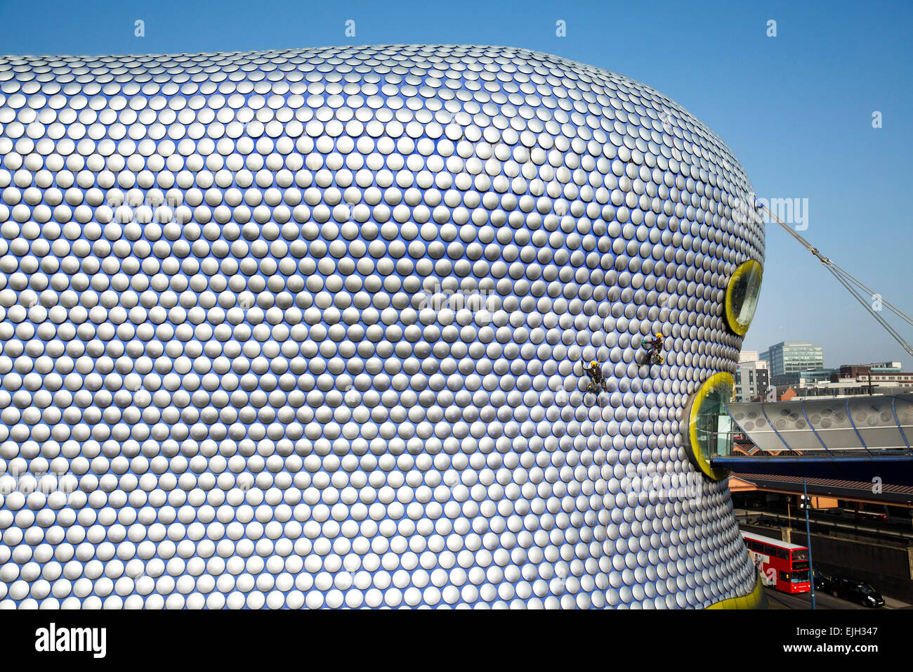 Workmen cleaning the decorative discs on the exterior of the Selfridges building in Birmingham Stock Photo