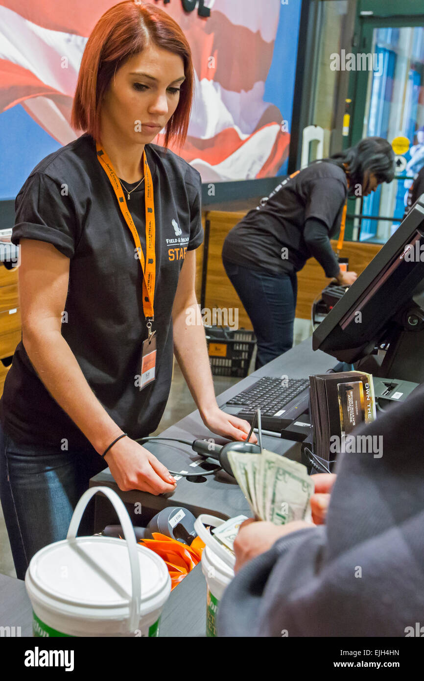 Troy, Michigan - A checkout clerk at the Field & Steam outdoors store. Stock Photo