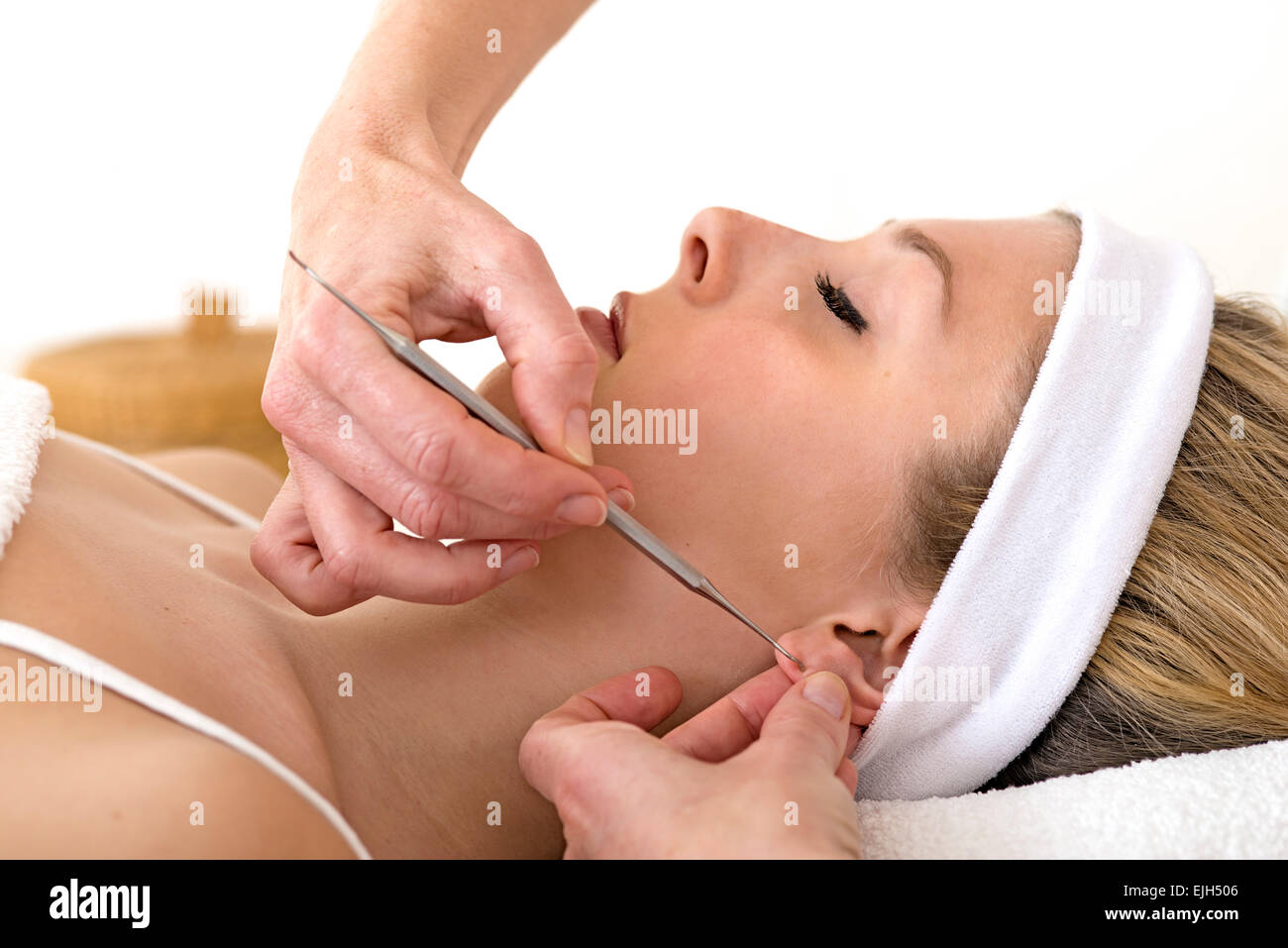 Alternative practitioner using auriculotherapy techniques. Homeopath using auriculotherapy or ear acupuncture techniques Stock Photo