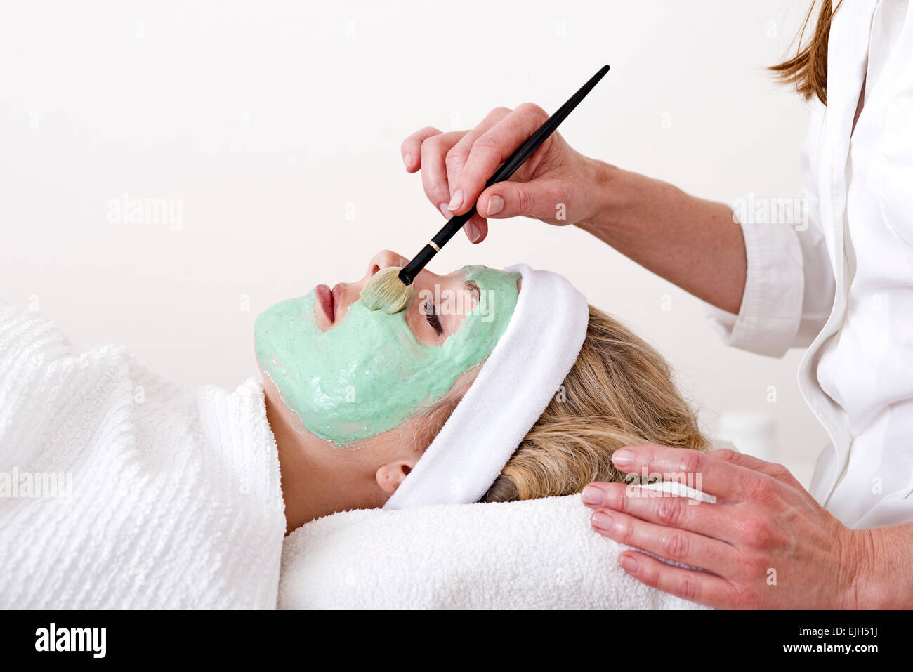 Beautician applying green mask on hi-res stock photography and images ...