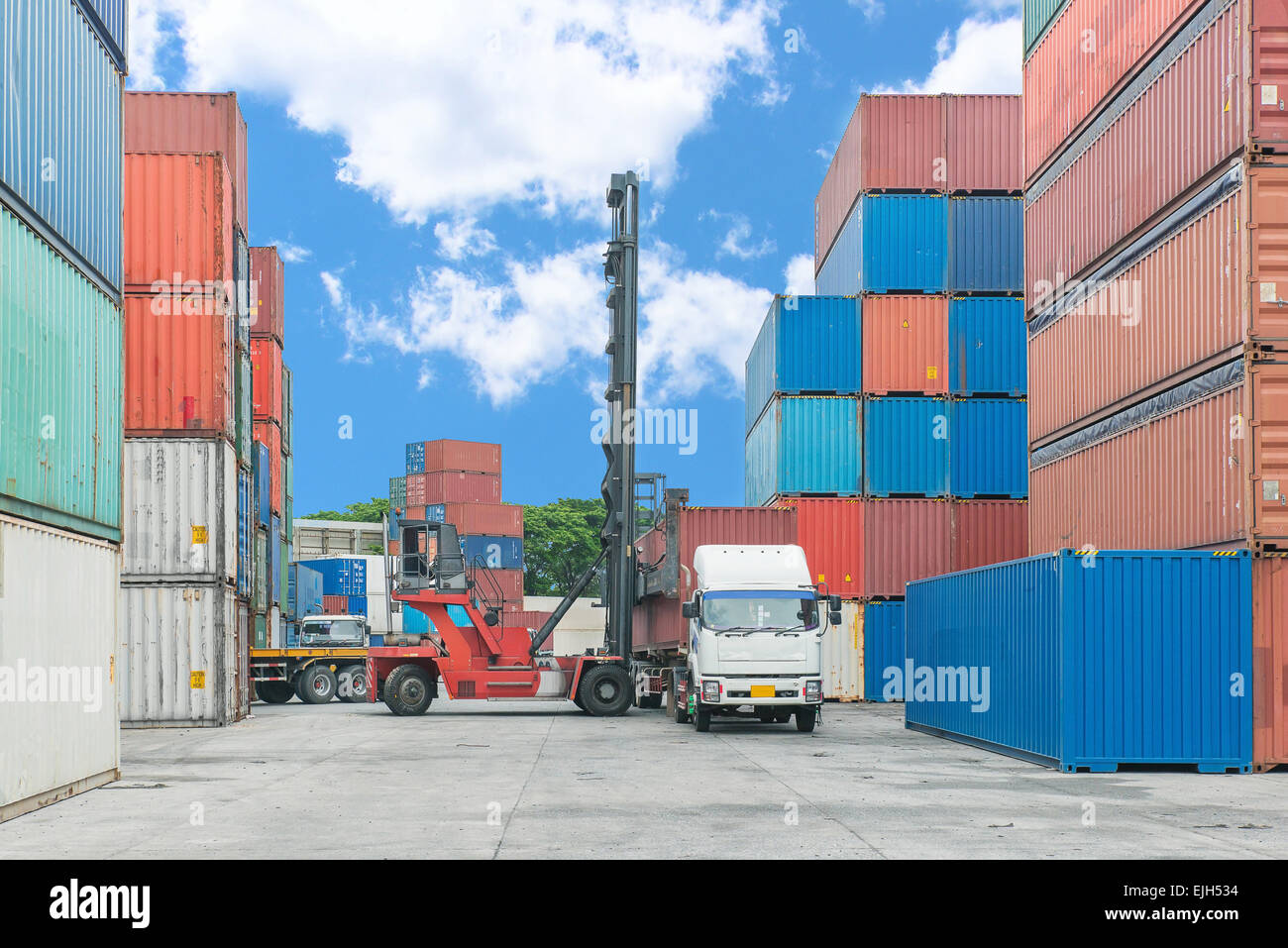 Forklift handling container box loading to truck Stock Photo