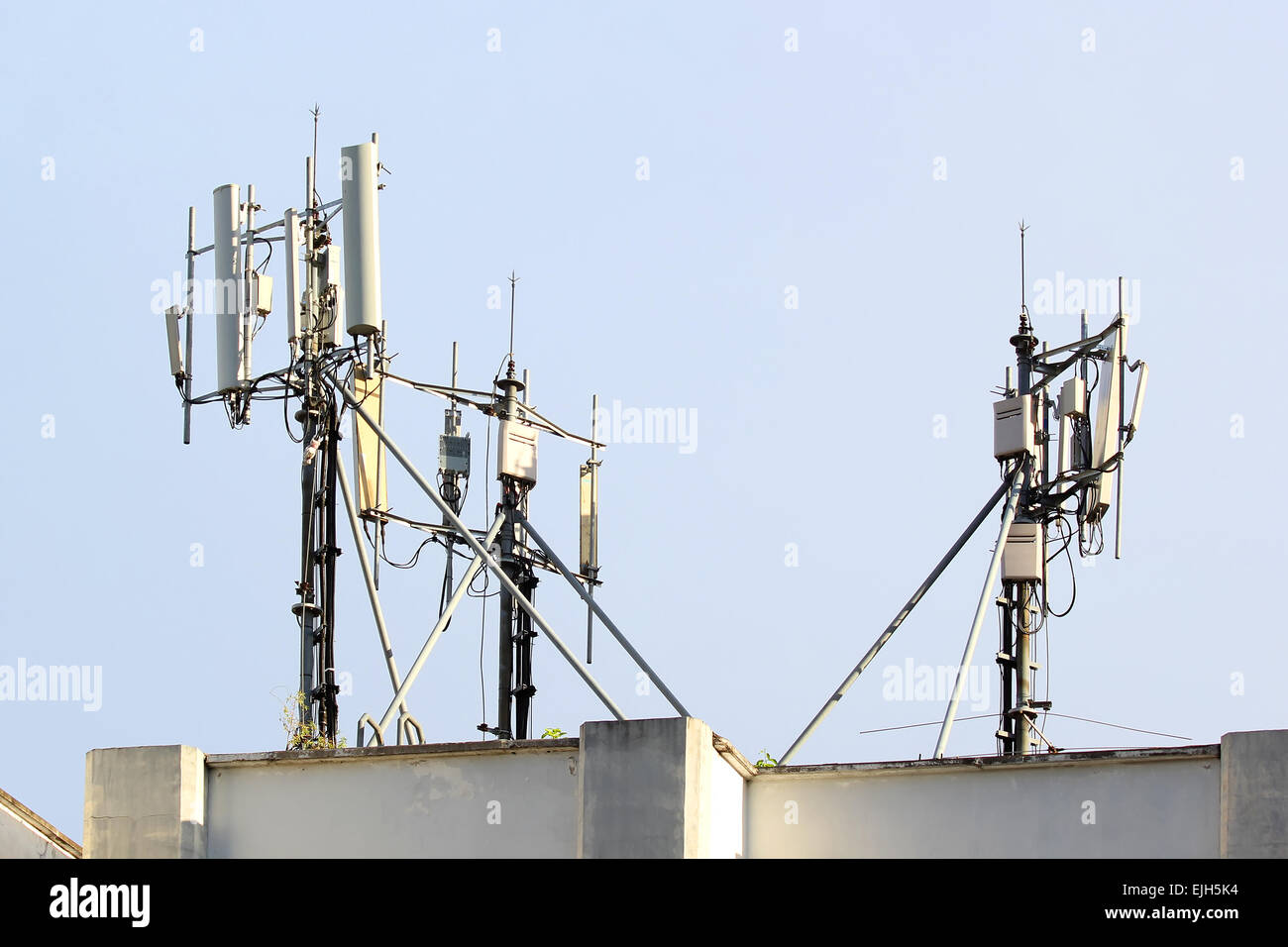 Mobile phone antenna on the top of roof Stock Photo