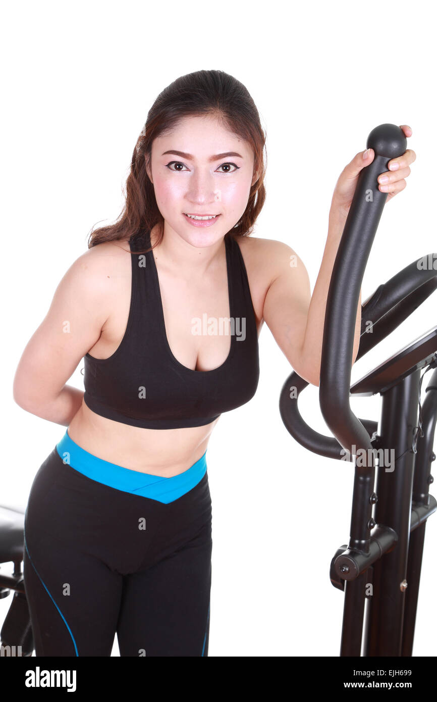 young woman doing exercises with exercise machine, on white background Stock Photo Alamy