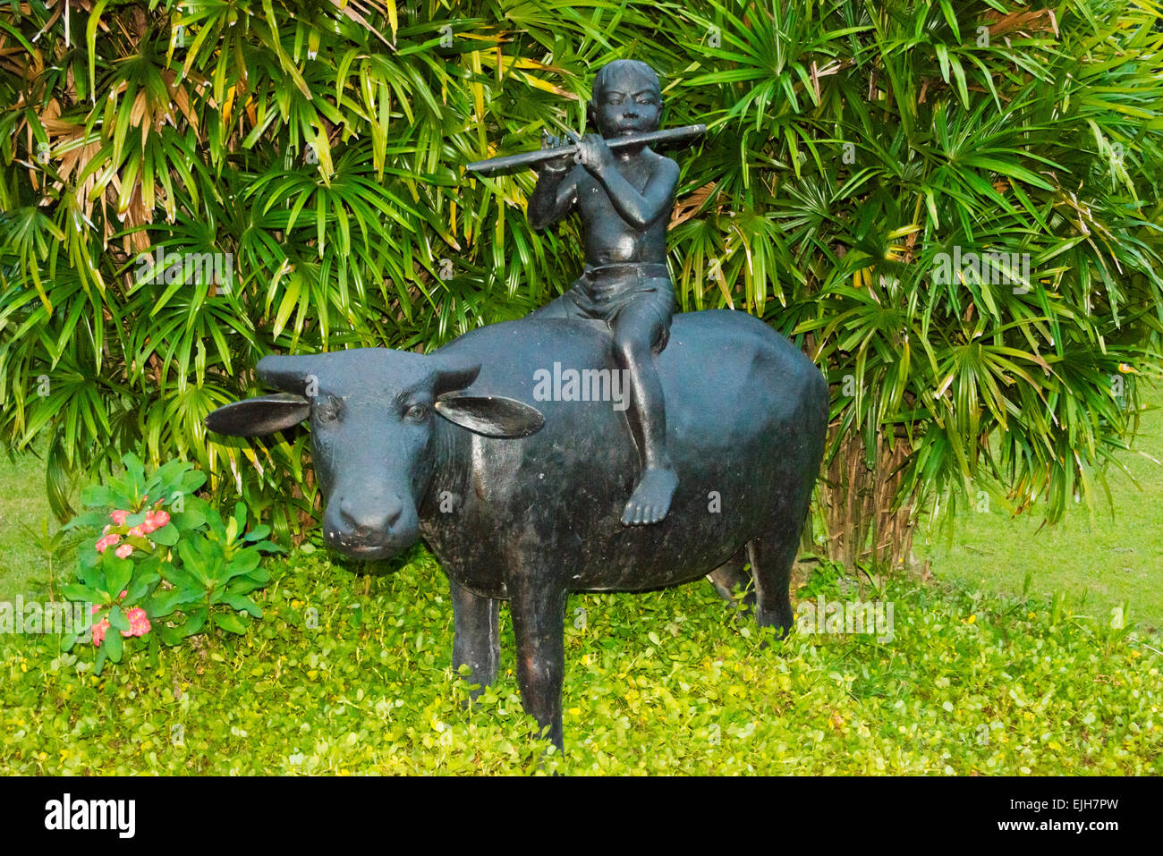 Statue of boy playing flute on water buffalo, Magelang,Central Java