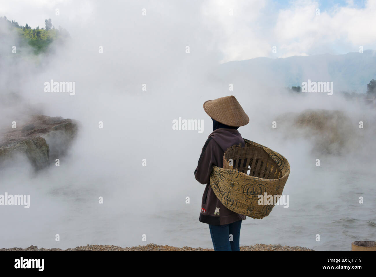 Farmer looking at active volcanic craters, Sikidang Crater, Dieng, Java, Indonesia Stock Photo