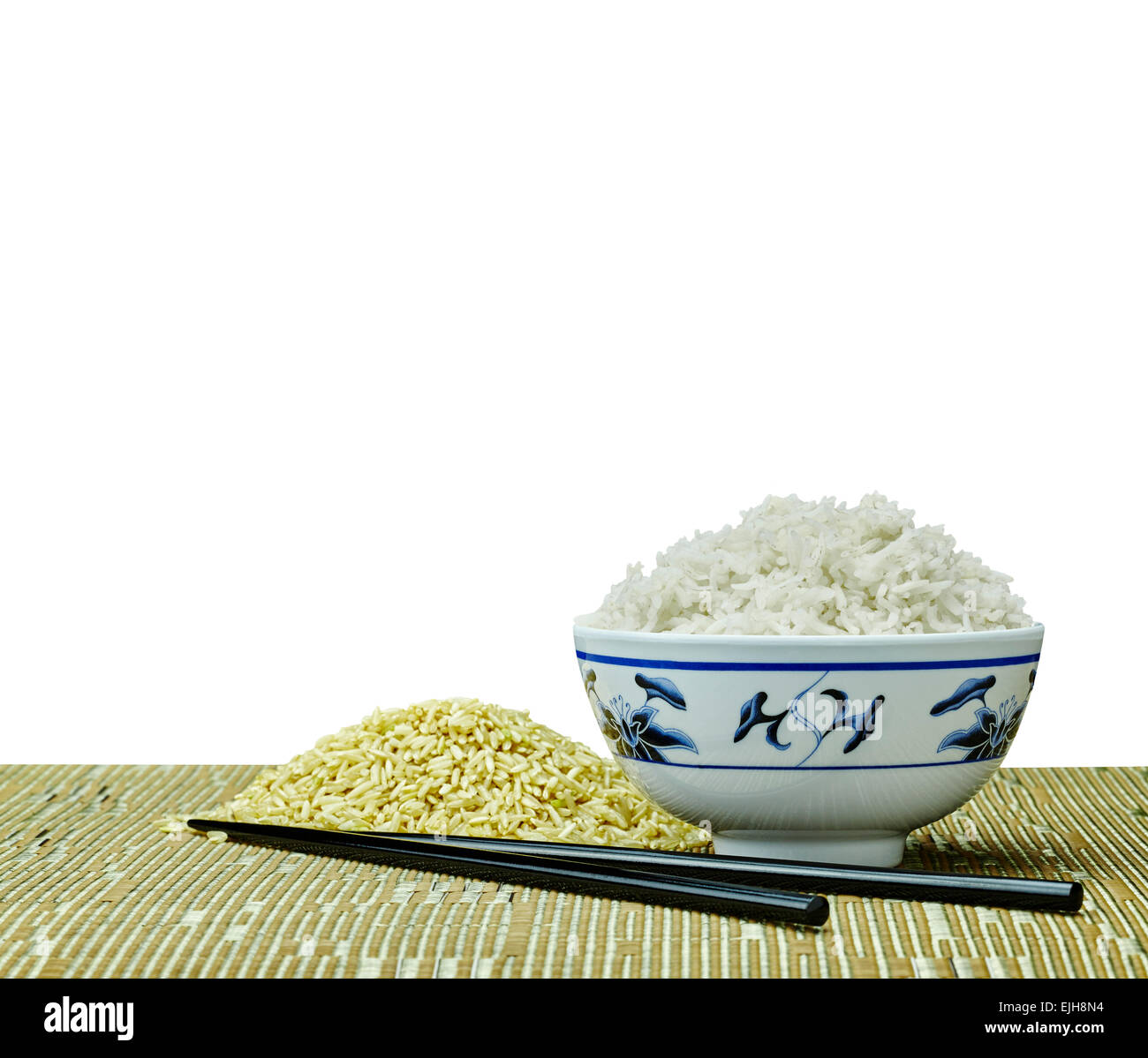 Raw and Cooked Natural Organic Brown Rice in Japanese Bowl on Tropical Place Setting with White Background Stock Photo