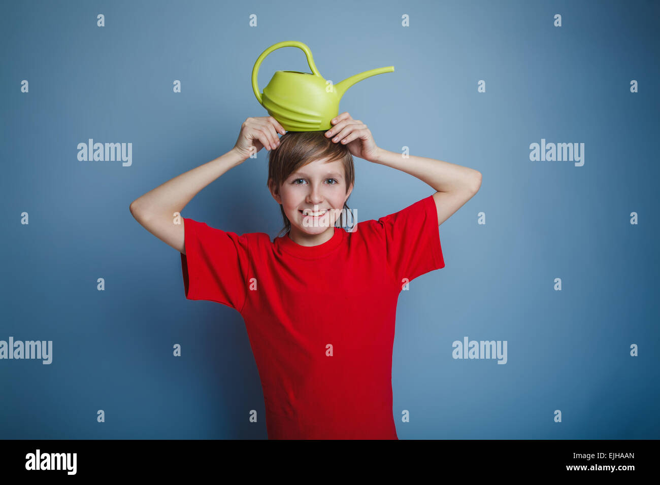 boy teenager European appearance in a red shirt brown hair water Stock