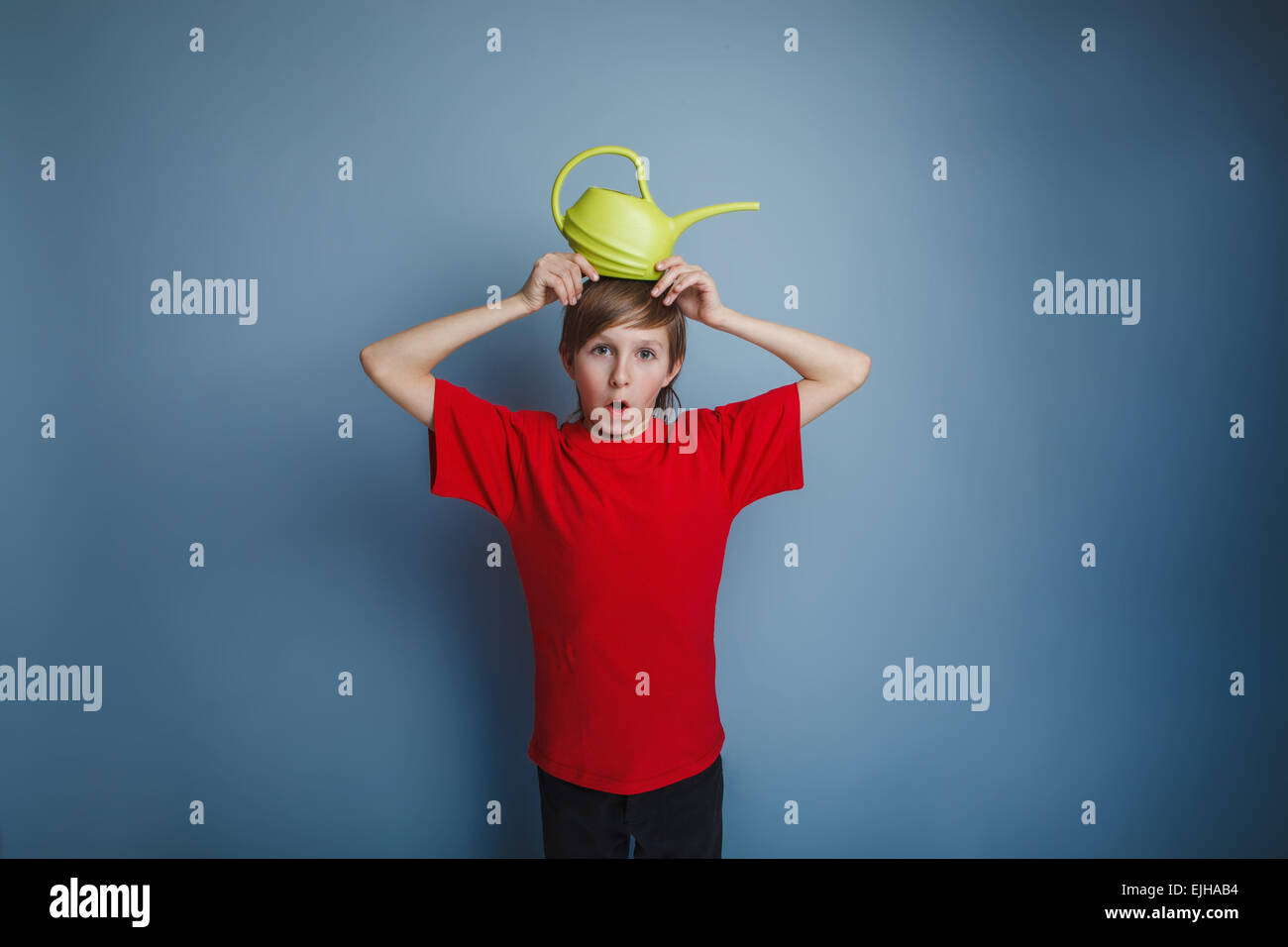 boy teenager European appearance in a red shirt brown hair water Stock