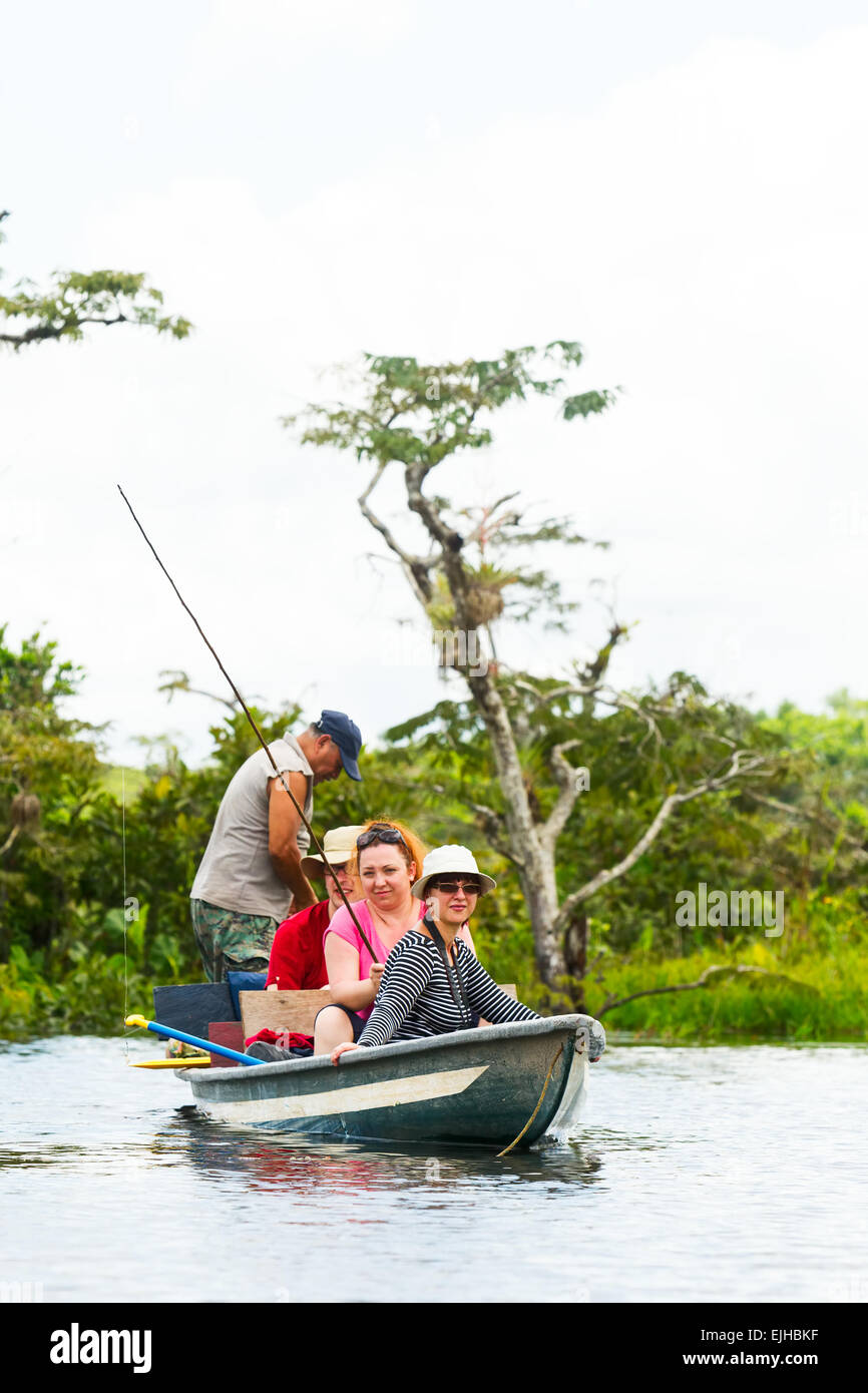 Tourist Boat Navigating On Murky Amazon Water In Cuyabeno Wildlife Reserve Stock Photo