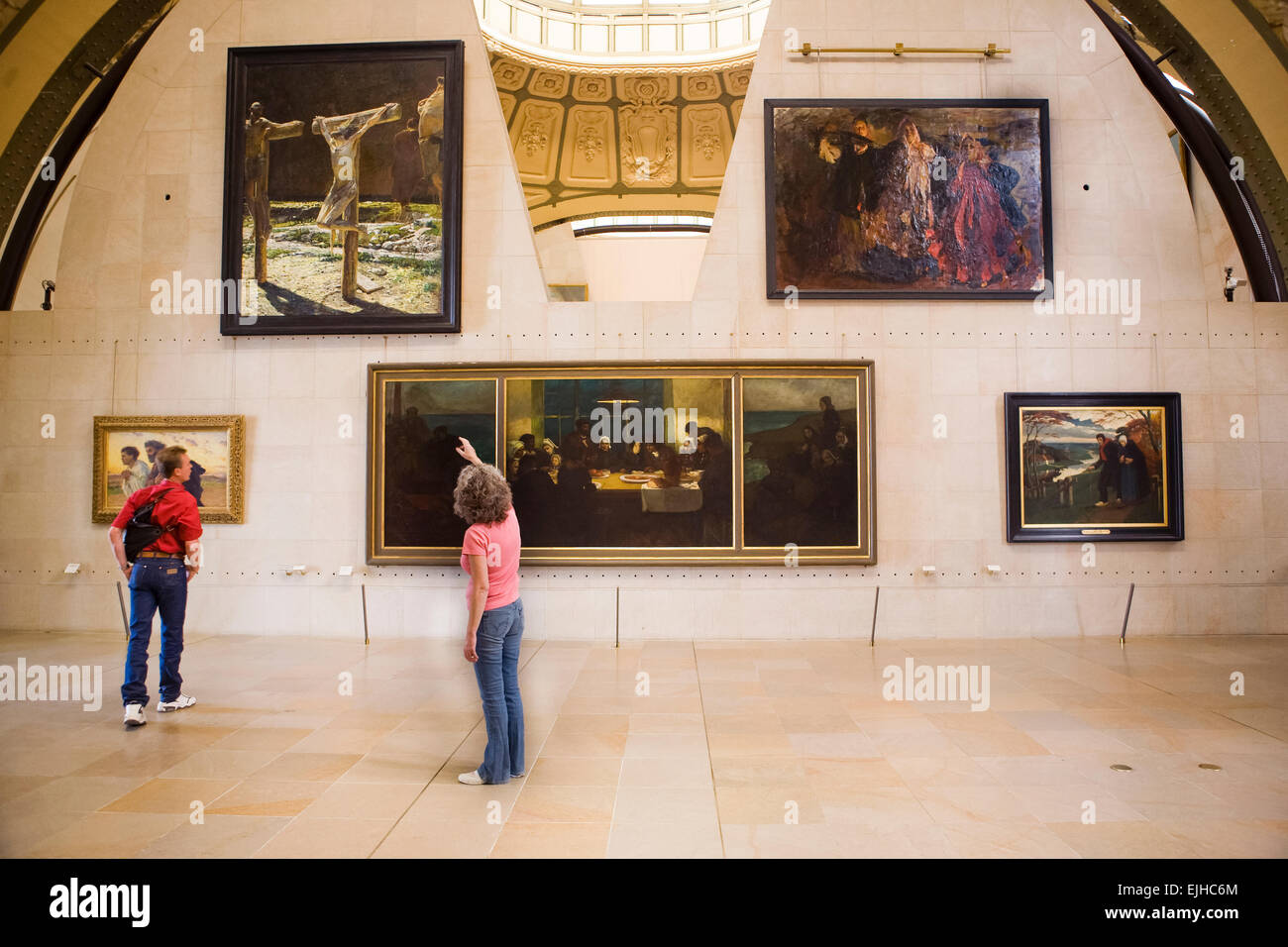 Two people looking at paintings in the Orsay Museum, Paris, France Stock Photo