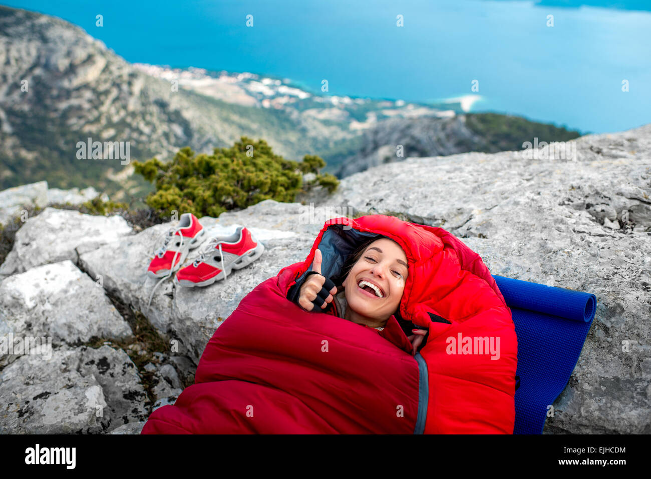 Woman in sleeping bag on the mountain Stock Photo