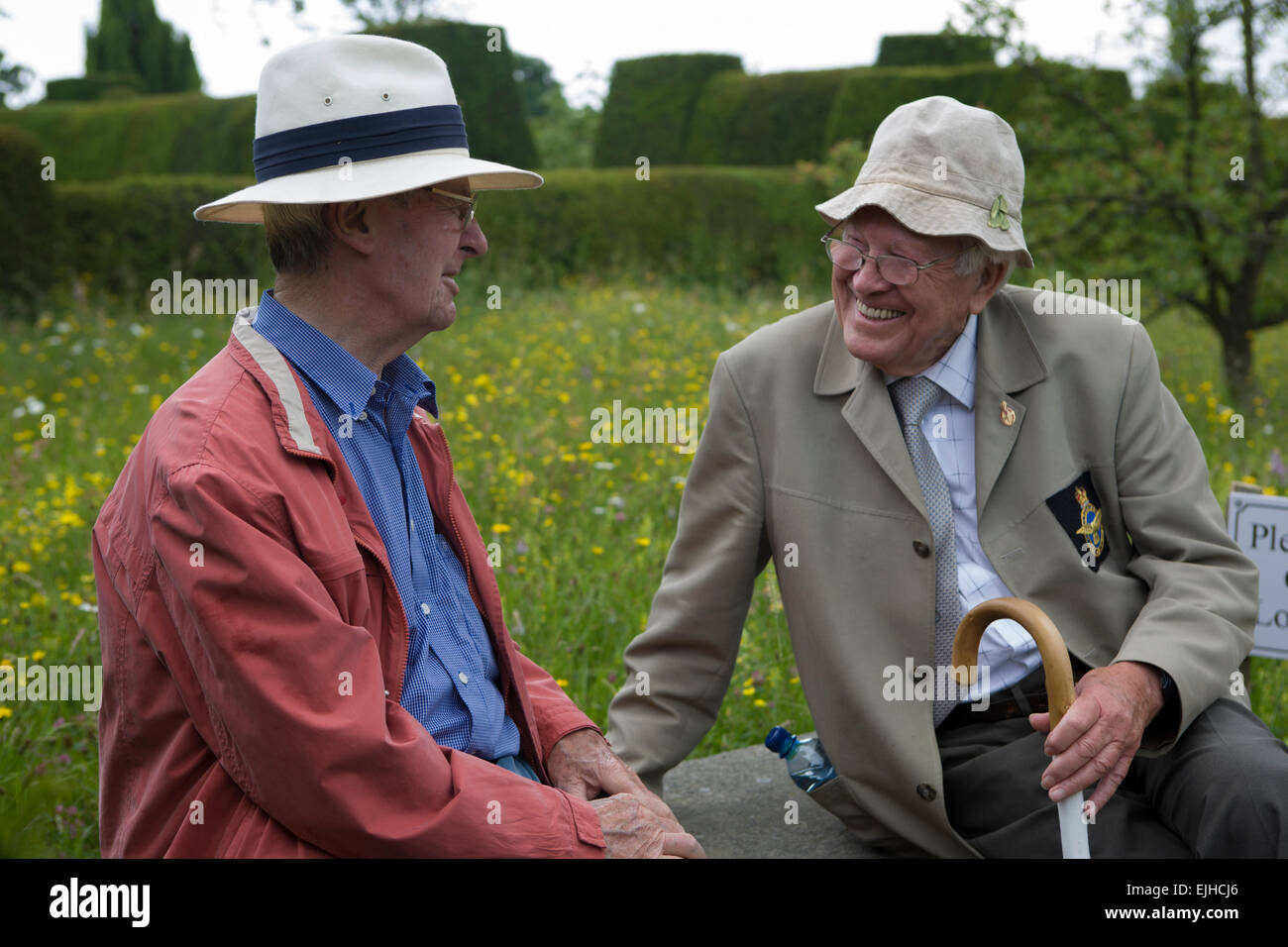 Two men in conversation outside Great Dixter House in Kent, England Stock Photo