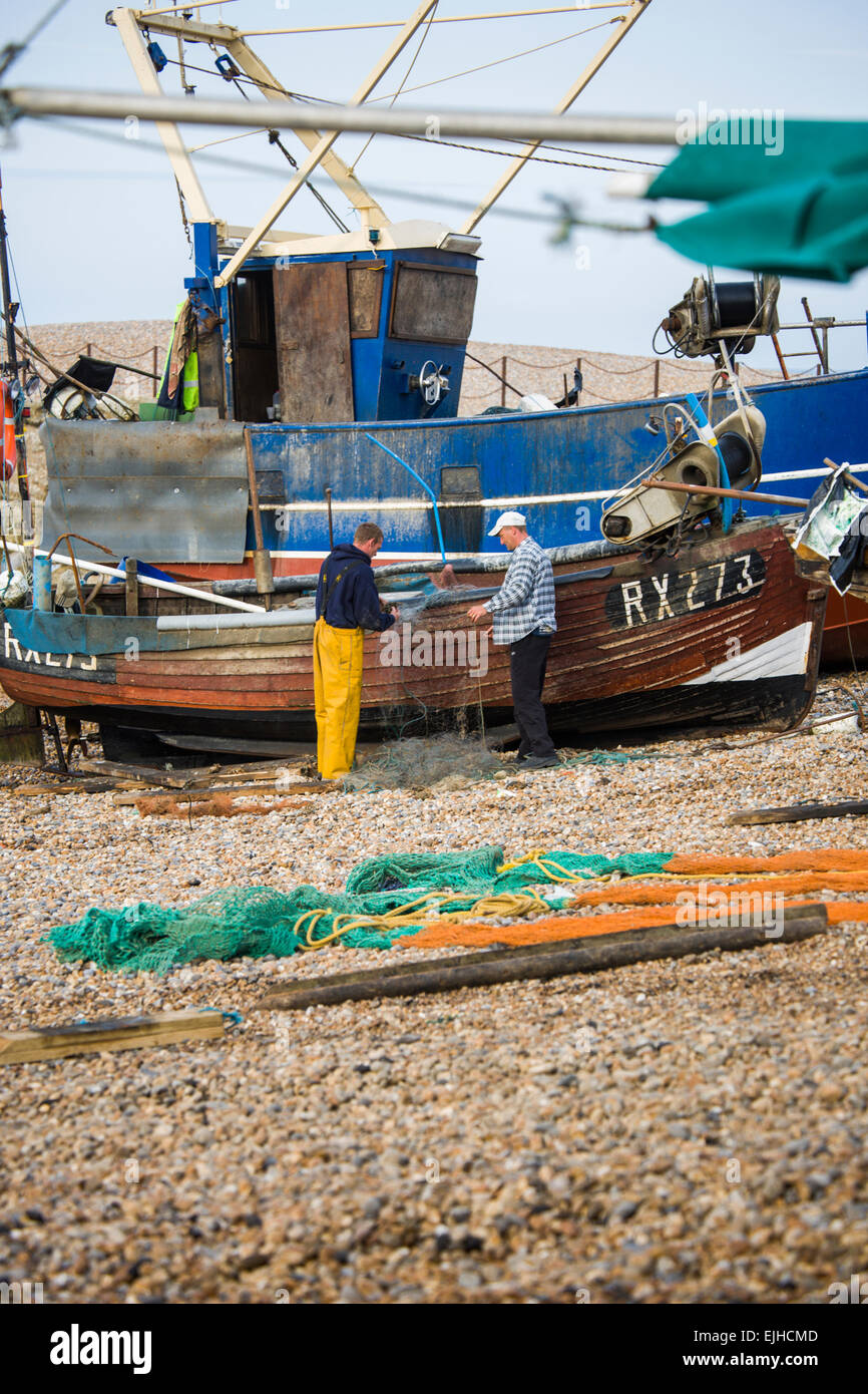 Commercial fishing boats and operations on the beach at Hastings, Sussex, England Stock Photo