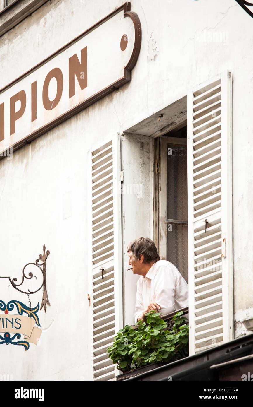 Man smoking out window in Montmartre, Paris, France Stock Photo Alamy