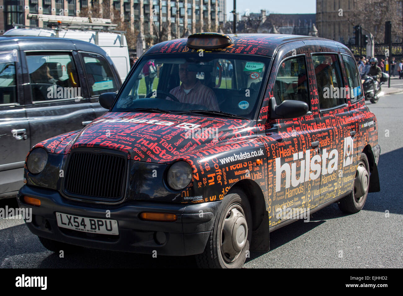 London cab with advertising, London, England Stock Photo