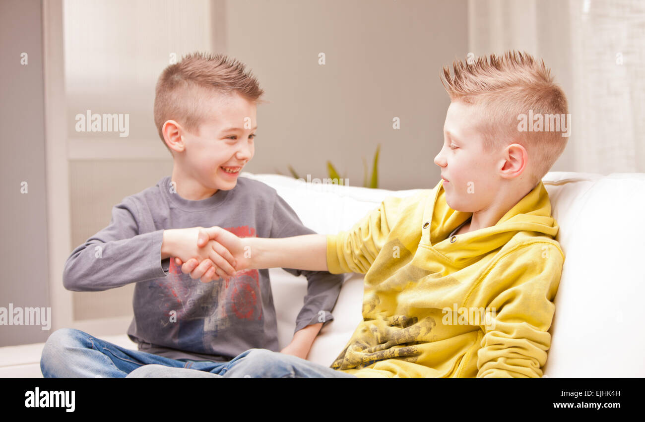 Two Kids Shaking Their Hands As Like As They Were Businessmen Stock Photo Alamy