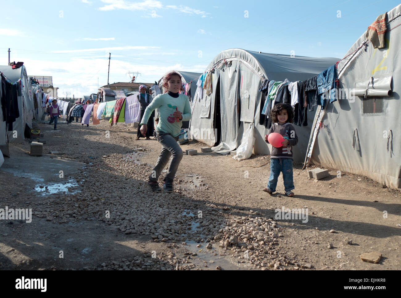 Kids and children playing in a refugee camp in Suruc, Turkish Kurdistan, Turkey. Daily life of refugees and displaced people from Kobane (Kobani), Syria Stock Photo