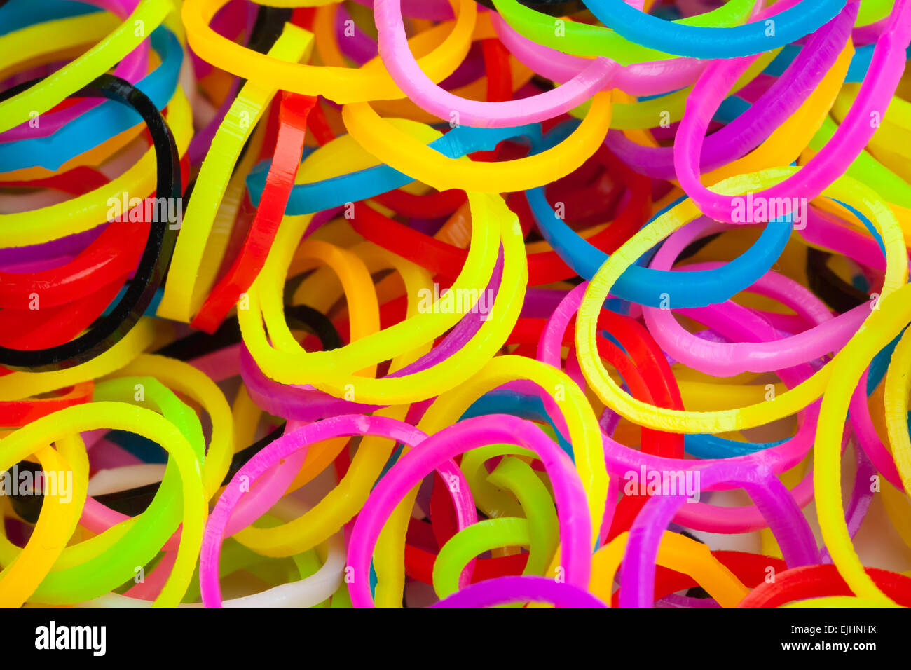 Macro photo of small round colorful rubber bands for making rainbow loom bracelets Stock Photo