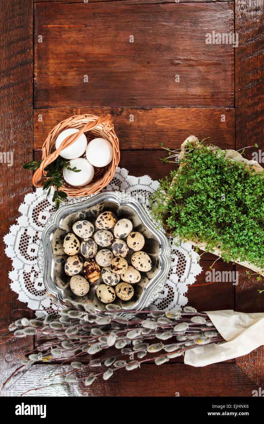 Easter composition of willow twigs with catkins, cress, quail eggs in ...
